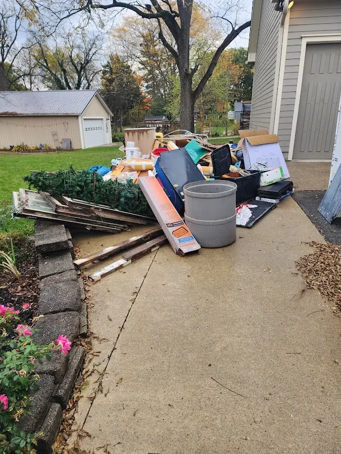 Dumpster being loaded with debris for 3 Yard Dumpster Rental in Fort Rucker